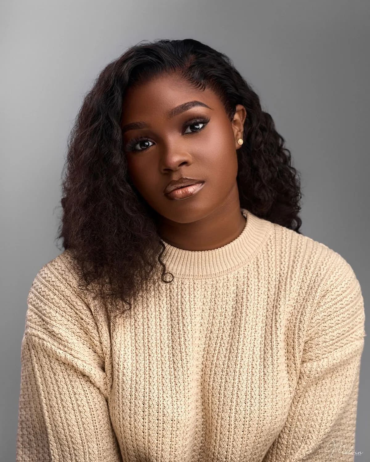 The same portrait, sharp, with clear eyes, curls and the knit of her sweater
